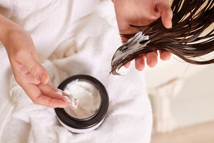 hair mask is applied to ends of dark brown hair