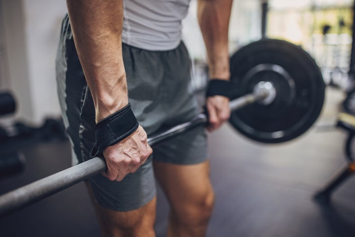 Man houd barbell vast met gewichten 